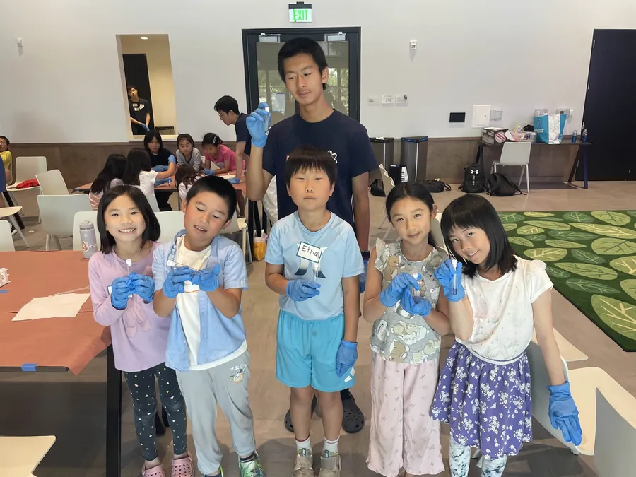 Library science event with volunteers and kids